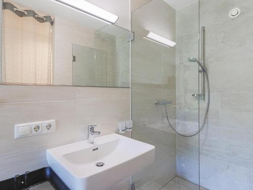 a white bathroom with a sink and a shower at Haus Rabl Hansi in Itter