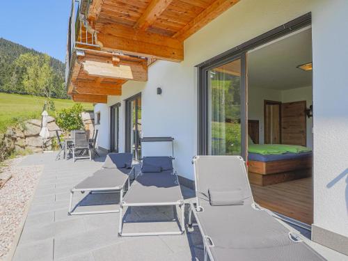 a patio with chairs and a bed and a window at Haus Rabl Hansi in Itter