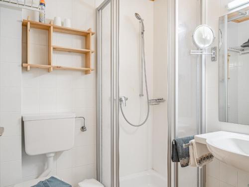 a bathroom with a shower and a toilet and a sink at Weberhof Top 3-4-5 in Brixen im Thale