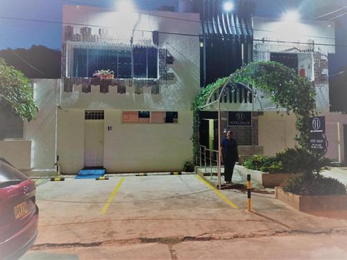 a man standing in front of a building at HOTEL BOUTIQUE SONNE BALOP Valledupar in Valledupar