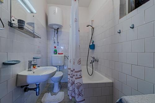 a bathroom with a sink and a toilet and a shower at Apartments with a parking space Orebic, Peljesac - 10178 in Orebić