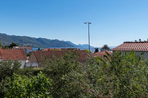 a view of roofs of houses with mountains in the background at Apartments with parking space Orebic, Peljesac - 646 in Orebić