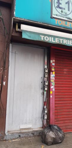 un par de puertas blancas en una tienda con una bolsa de basura delante en Marahanata Jadwin 1Beautifull 1 Bedroom Flat en Londres