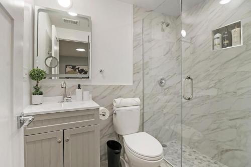 a bathroom with a shower and a toilet and a sink at 2BR Apartment close to Local Cafes & Stores - Magnolia G in Chicago