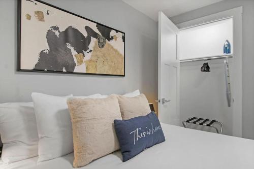 a bedroom with a white bed with a map on the wall at 2BR Apartment close to Local Cafes & Stores - Magnolia G in Chicago
