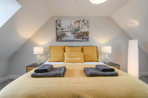 a bedroom with a large bed with two pillows at Number 51, Halesworth in Halesworth