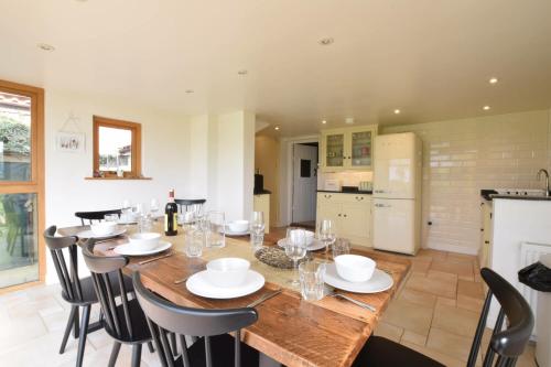 a dining room with a large wooden table and chairs at Skelder, Parham in Parham