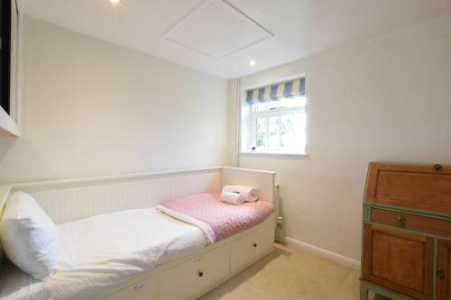 a small bedroom with a bed and a window at Skelder, Parham in Parham