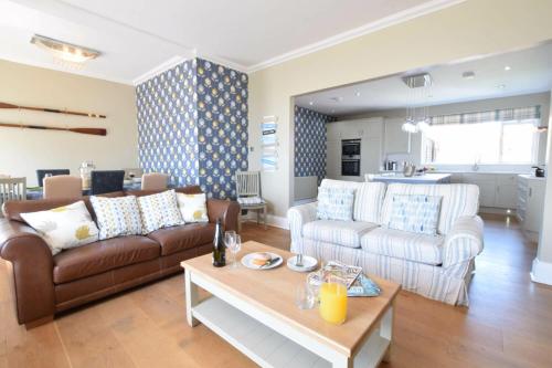 a living room with a couch and a table at St Marys View, Southwold in Southwold