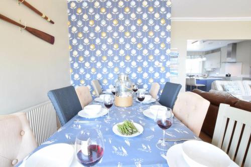 a blue table with wine glasses and food on it at St Marys View, Southwold in Southwold