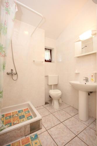a bathroom with a toilet and a sink and a shower at Studio Punta kriza 383a in Punta Križa