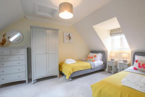 a small bedroom with two beds and a dresser at The Sandy House, Leiston in Leiston