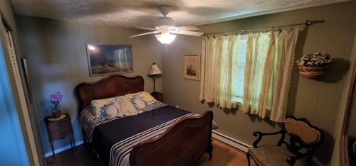 a bedroom with a bed and a ceiling fan at Mountain Top Chalet in Egypt Bend Estates