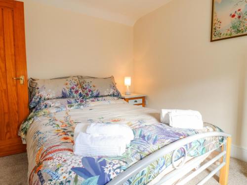 a bedroom with a bed with towels on it at 7 The Green in Lichfield