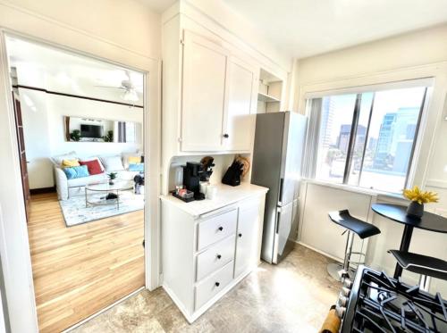 a kitchen with a refrigerator and a dining room at STUDIO- Sleeps 2 with Queen Mary and Ocean View in Long Beach