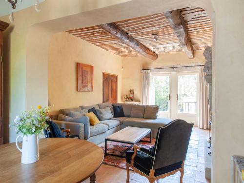 a living room with a couch and a table at Bastide with pool and panoramic views in Ménerbes