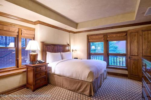 a bedroom with a large bed and windows at Aspen Mountain Residences, 2 Bedroom Luxury Residence Club Condo in Aspen