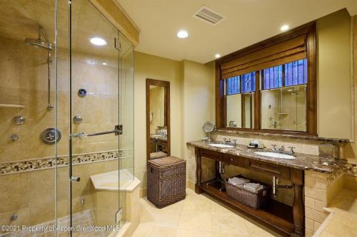 a bathroom with a shower and two sinks and a glass shower stall at Aspen Mountain Residences, 2 Bedroom Luxury Residence Club Condo in Aspen