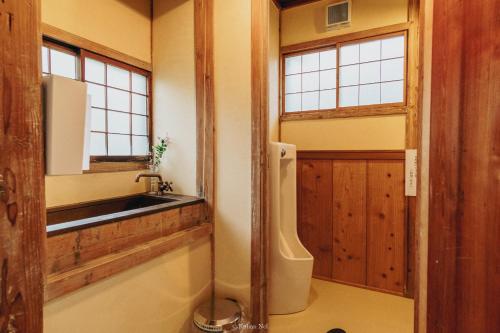 a bathroom with a sink and a sink at Japan's oldest remaining company housing in Ikuno
