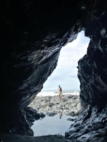 a man standing inside of a cave at Mira Olas Cabins in Pavones