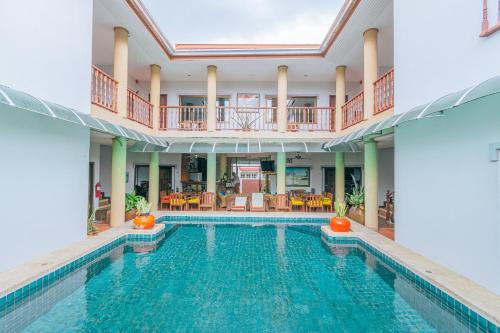 an indoor swimming pool with a large house at Evergreen boutique Hua Hin in Hua Hin