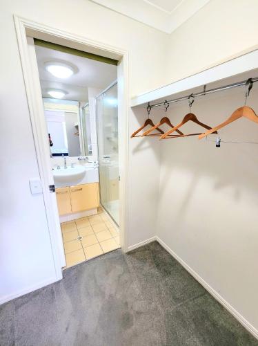 a bathroom with a walk in shower and a mirror at Fairways Golf & Beach Retreat Bribie Island in Woorim