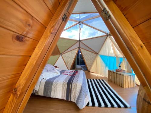 a bedroom with a bed in a large tent at Glamping - Campamento Invierno de Luxury Camp in Paipa