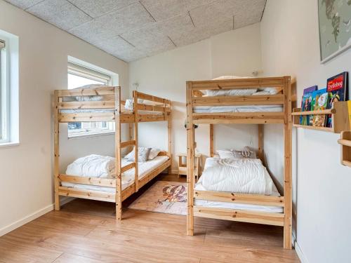 a room with three bunk beds in it at Holiday home Væggerløse CCXIII in Bøtø By