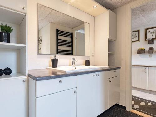 a bathroom with a sink and a mirror at 8 person holiday home in Bagenkop-By Traum in Bagenkop