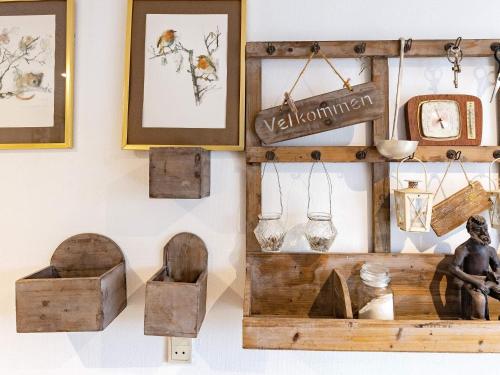 a shelf with various wooden items on a wall at 8 person holiday home in Bagenkop-By Traum in Bagenkop