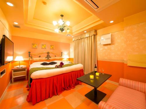 a hotel room with a bed and a couch at Hotel Gallery (Adult Only) in Kobe