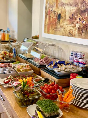 a buffet with many different types of food on a table at Weinbergs Loge in Ernst