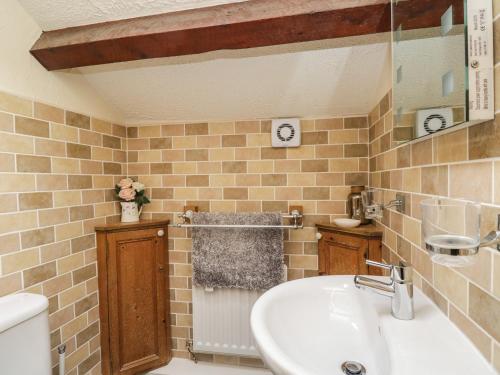 a bathroom with a sink and a toilet at The Cottage at Graysondale Farm in Cockermouth