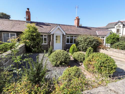 an old house with bushes in front of it at Riverlea in Rhyl