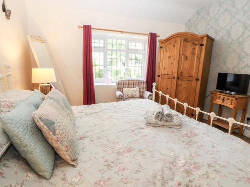 a bedroom with a large bed and a window at Riverlea in Rhyl