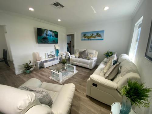a living room with white couches and a table at Relax 521 in Miami