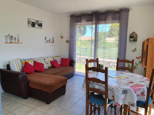 un salon avec un canapé et une table dans l'établissement Gite LOCMOUSTERU, à Moustéru