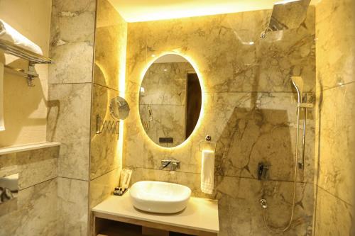 a bathroom with a sink and a mirror at Hotel Golden Lotus in Amritsar