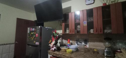 a kitchen with wooden cabinets and a refrigerator at jazmines point in Lima
