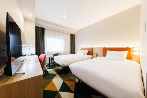 Postel nebo postele na pokoji v ubytování JR-East Hotel Mets Omori