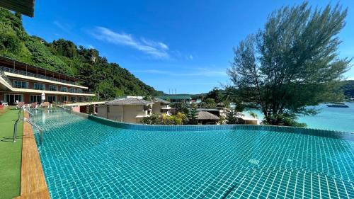 a swimming pool with a view of the river at Phi Phi Cliff Beach Resort-SHA Plus in Phi Phi Islands