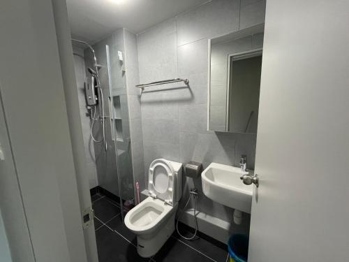 a bathroom with a toilet and a sink at SEAVIEW LUXURY CONDO HOMESTAY 2Bed 2bath Jesselton Quay by R2 Residence in Kota Kinabalu