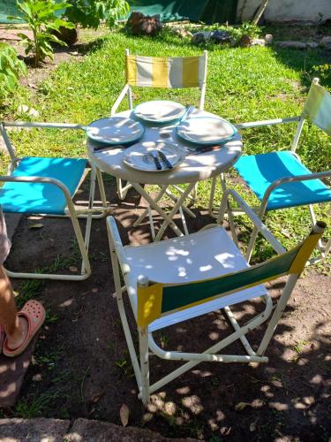 a table and two chairs and a table and chairs at Casa del arbol hostel in Concepción del Uruguay