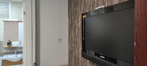 Elle comprend une télévision à écran plat suspendue au mur. dans l'établissement Midtown Hotel Apartments 305 (0+1), à Istanbul