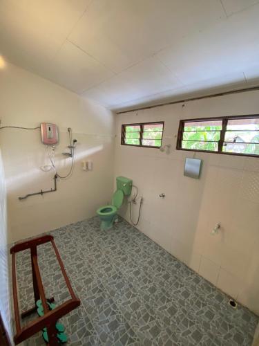 a bathroom with a green toilet in a room at Kejora Homestay in Kangar