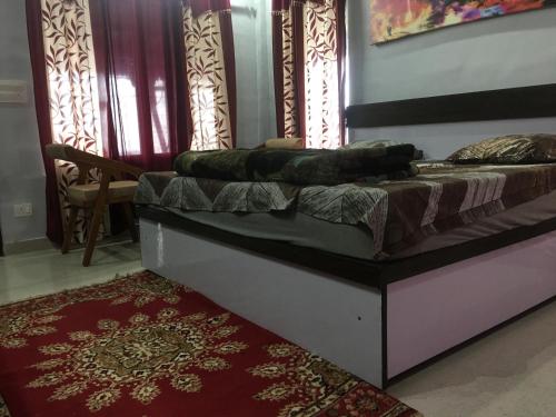 a bed in a room with a rug and windows at LaCliff Nature Home in Dhanaulti