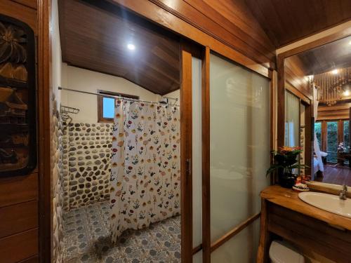 a bathroom with a shower and a sink at Esmeralda View Resort - SHA Extra Plus in Ko Yao Yai