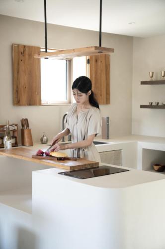 a woman standing in a kitchen preparing food at Haru YeonGa in Gyeongju