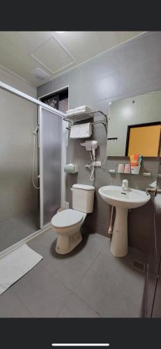 a bathroom with a toilet and a sink at Ba Ba Xiao Wu 2 in Jinning