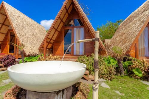 a bath tub in front of a house at Segara Camp Kintamani in Kintamani